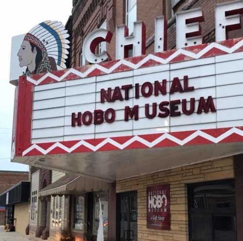 Sign for the National Hobo Museum outside the Chief Theater, featuring a Native American chief illustration.