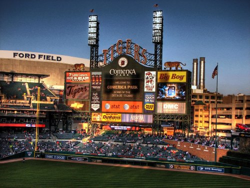 A view of Comerica Park, home of the Detroit Tigers, with a scoreboard and fans in the stands.