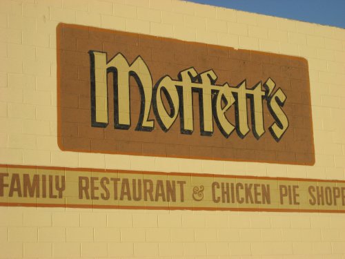 Sign for Moffett's Family Restaurant & Chicken Pie Shoppe, featuring bold lettering on a light-colored wall.