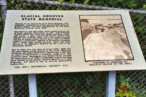 Sign at Glacial Grooves State Memorial, explaining glacial grooves on Kelleys Island, with a historical photo.