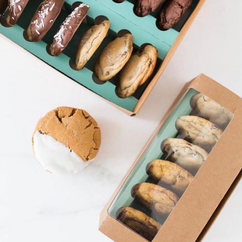 Two boxes of cookies: one with chocolate-covered cookies and another with assorted cookies, plus a single cookie on the side.