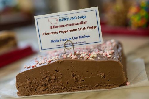 A close-up of chocolate peppermint stick fudge with a sign that reads "Homemade" and "Made Fresh In Our Kitchen."