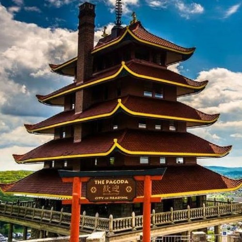 A multi-tiered pagoda with red and gold accents against a blue sky, located in Reading, Pennsylvania.