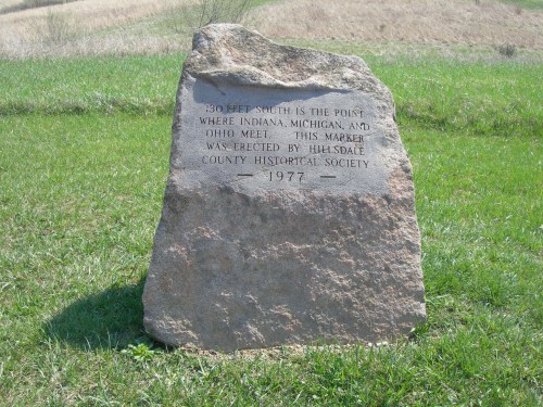 A stone marker indicating the point where Indiana, Michigan, and Ohio meet, erected by the Hillsdale County Historical Society in 1977.