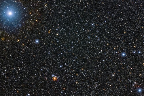 A starry night sky filled with countless stars, including bright celestial bodies and distant galaxies.