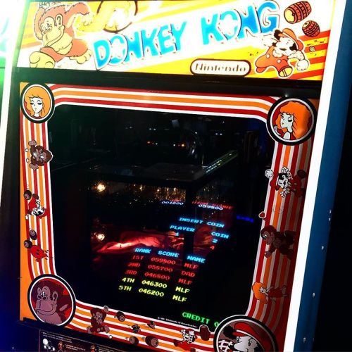 Close-up of a vintage Donkey Kong arcade machine, featuring the game screen and colorful artwork.