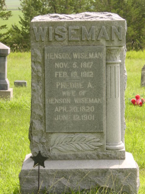 Gravestone of Henson Wiseman (1817-1912) and Phedre A. Wiseman (1820-1901) in a grassy cemetery.