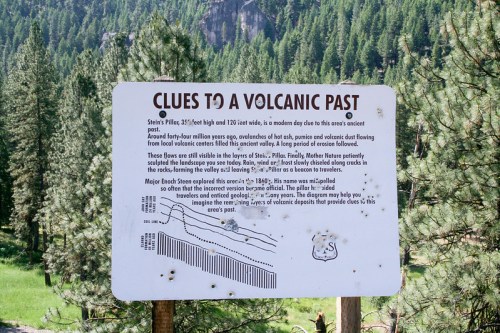 Sign detailing geological clues to a volcanic past, with illustrations and information about the area's history and features.