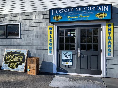 Exterior of Hosmer Mountain, a family-owned business, featuring a welcoming entrance and open sign.