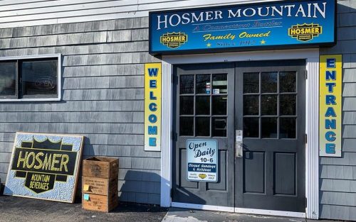 Exterior of Hosmer Mountain, a family-owned business, featuring a welcoming entrance and open sign.