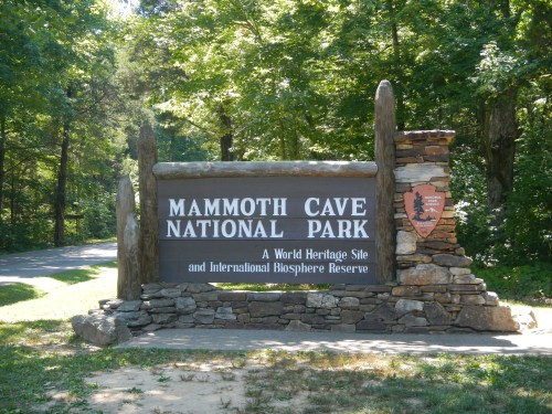 Sign for Mammoth Cave National Park, surrounded by trees, highlighting its status as a World Heritage Site.