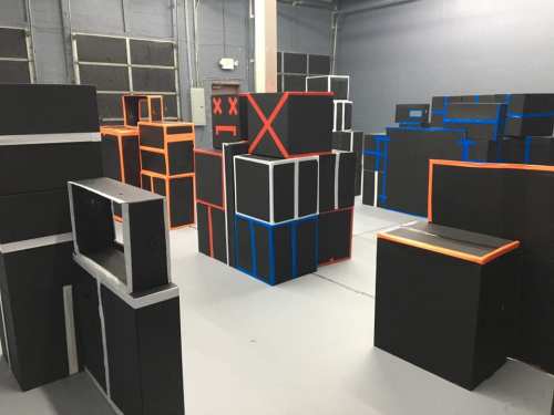 A room filled with various black boxes and structures, outlined in bright colors like orange and blue.