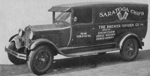 Vintage delivery truck with "Saratoga Chips" branding, featuring a boxy design and classic wheels.