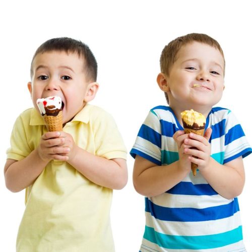 Two smiling boys hold ice cream cones, one with chocolate and the other with vanilla, against a white background.