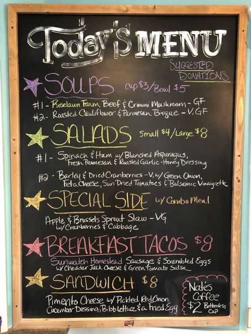 Chalkboard menu featuring soups, salads, a special side, breakfast tacos, and a sandwich with suggested donations.