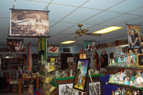 A vintage shop interior filled with various decorations, photos, and memorabilia hanging from the ceiling.