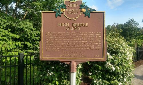 Historical marker for High Bridge Glens in Ohio, detailing its significance and history. Surrounded by greenery.