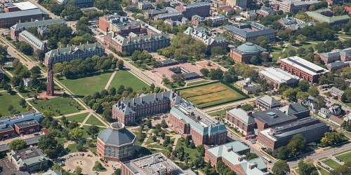 Aerial view of a university campus featuring green spaces, buildings, and pathways.