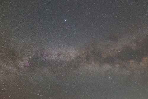 A stunning view of the night sky filled with stars, the Milky Way, and several shooting stars.
