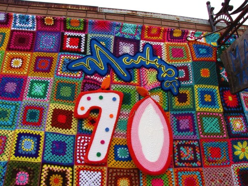 Colorful crochet wall art featuring the number "70" and the word "Musing" in vibrant letters.