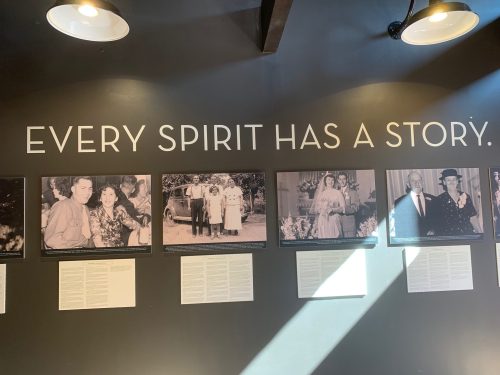 A wall display featuring black-and-white photos with the text "Every Spirit Has a Story" above them.