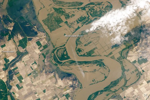 Aerial view of the winding Mississippi River, surrounded by farmland and clouds, with Tennessee and Missouri visible.