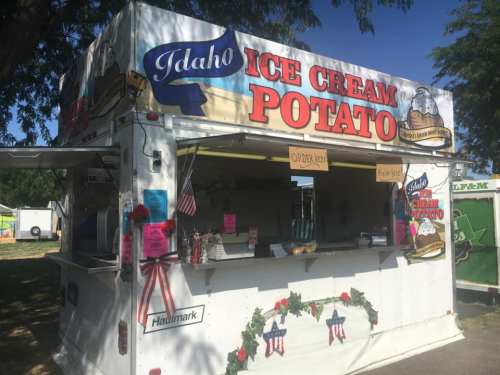 A food truck named "Idaho Ice Cream Potato" with colorful signage and a festive decor, serving ice cream treats.