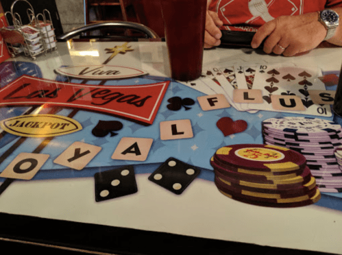 A tabletop featuring casino-themed graphics, including poker chips, playing cards, and dice.