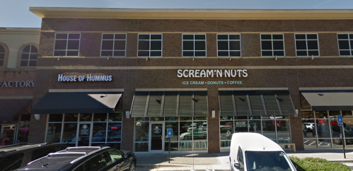 Exterior view of a building featuring "House of Hummus" and "Scream'n Nuts" ice cream and coffee shop.