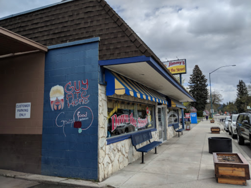 A colorful restaurant exterior with a sign reading "Jimmy's on the Street" and a mural saying "Guy Ate Here."