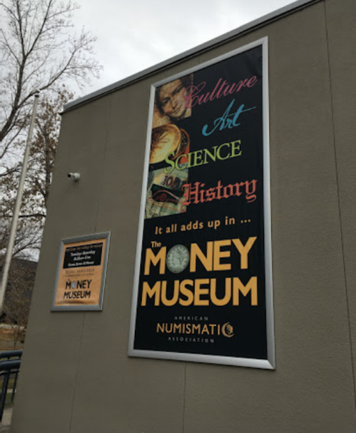 Sign for the Money Museum featuring words like "Culture," "Art," "Science," and "History" with a colorful design.