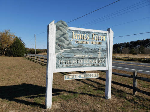 Sign for James Farm Ecological Preserve, featuring a scenic illustration, with "Public Welcome" at the bottom.