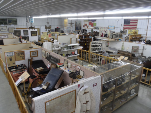 A spacious museum filled with various exhibits, artifacts, and displays, showcasing historical items and memorabilia.