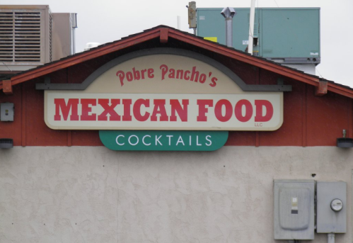 Sign for Pobre Pancho's featuring "Mexican Food" and "Cocktails" in bold lettering.