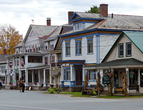 Charming street view of historic buildings with colorful facades and autumn decorations in a small town.