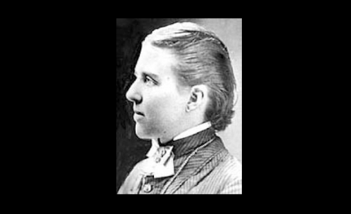 Black and white profile portrait of a young person with short hair, wearing a formal suit and bow tie.