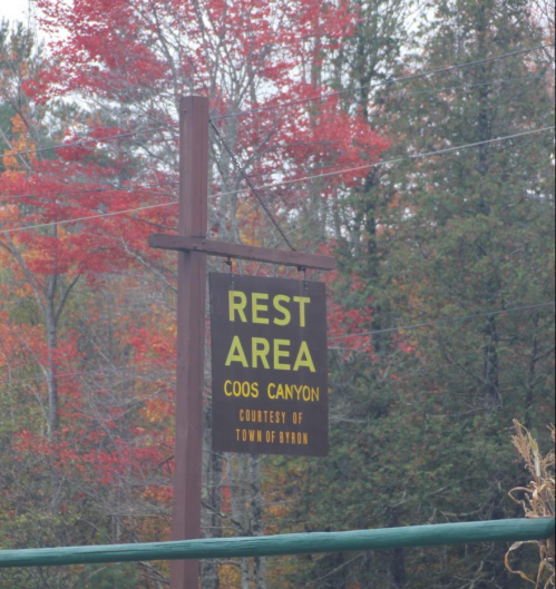 Sign for "Rest Area" at Coos Canyon, surrounded by vibrant autumn foliage.