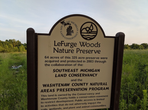 Sign for LeFurge Woods Nature Preserve, detailing its size and conservation efforts by local organizations.
