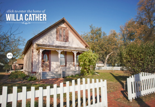 A pink house with white trim and a picket fence, surrounded by trees, labeled as the home of Willa Cather.