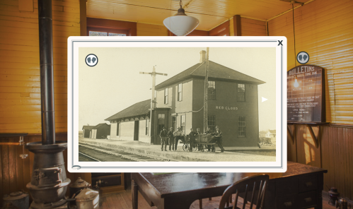 Historic photo of a train station labeled "Red Cloud," with people gathered outside and a vintage interior setting.