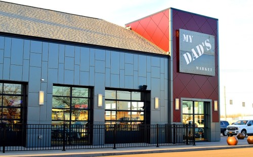 Exterior of "My Dad's Market," featuring a modern design with large windows and a prominent sign.