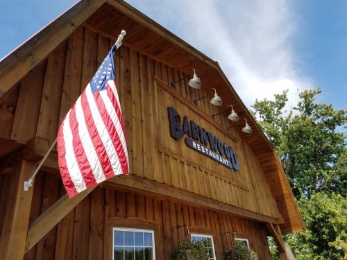 Exterior of a wooden restaurant building with an American flag hanging and a sign that reads "Lankwood Restaurant."