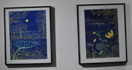 Two framed artworks featuring vibrant blue backgrounds with nature scenes, including trees, flowers, and a moonlit sky.