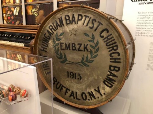 A vintage drum from the Hungarian Baptist Church Band, Buffalo, N.Y., dated 1915, displayed in a museum.