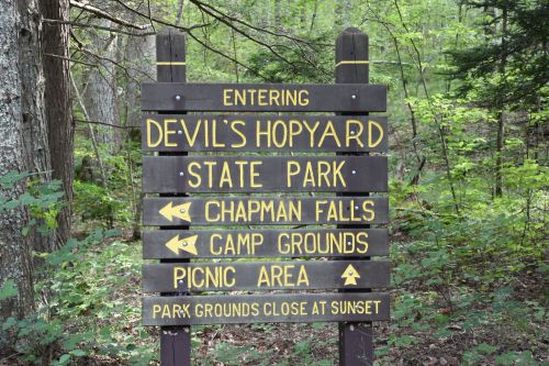 Sign for Devil's Hopyard State Park, indicating directions to Chapman Falls, campgrounds, and picnic area.