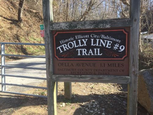 Sign for Trolley Line #9 Trail, indicating a 1.1-mile path on Oella Avenue, Baltimore County Recreation & Parks.