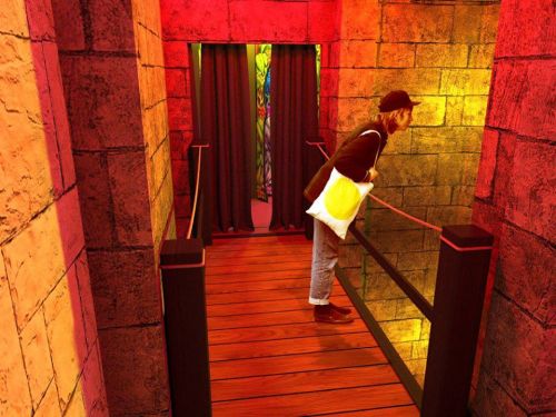 A person leans over a wooden railing in a brightly lit, colorful corridor with stone walls and curtains.