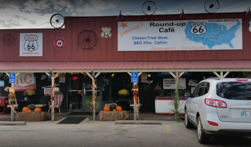 Exterior of Jimmy's Round-up Café on Route 66, featuring a rustic facade, pumpkins, and a welcoming entrance.