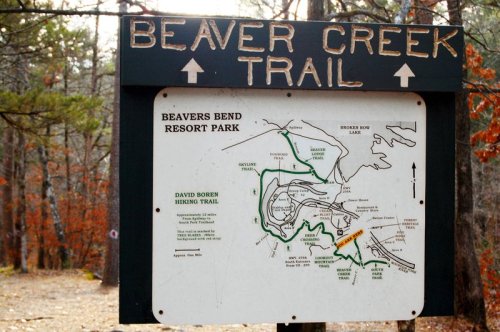 Sign for Beaver Creek Trail at Beavers Bend Resort Park, featuring a map of hiking trails and park layout.