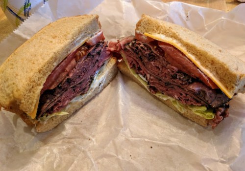 A hearty sandwich with layers of roast beef, cheese, lettuce, and tomato, served on whole grain bread.